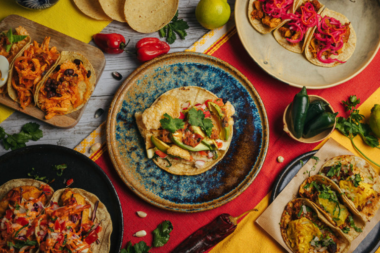 Plano cenital con distintos platos con tacos