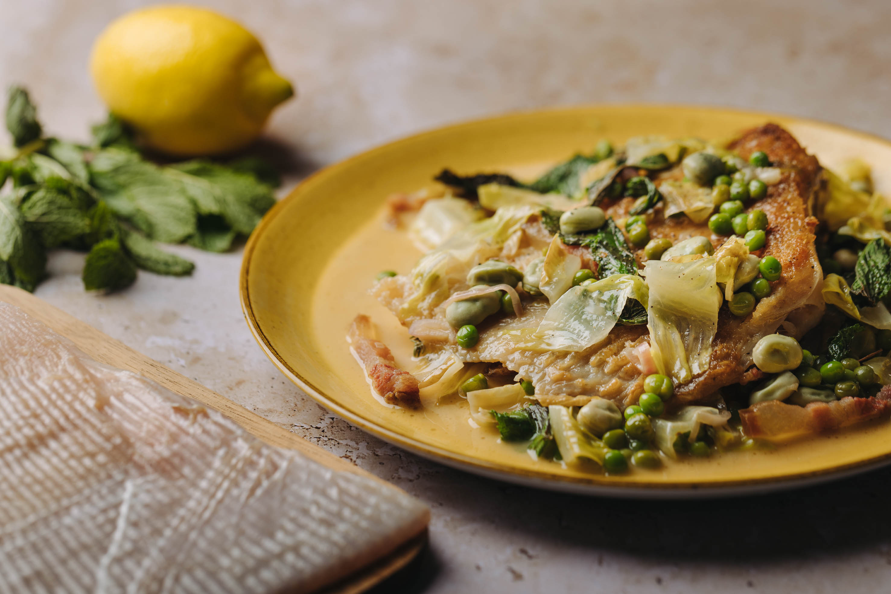 Skate wing with peas and fava beans