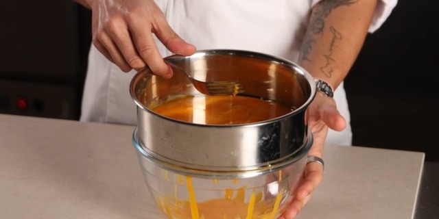 Strain egg yolks whit a sieve for Pudim