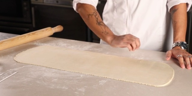 Roll out puff pastry for Pastel de Nata