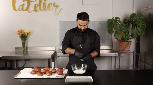 Coat the fried donuts with sugar
